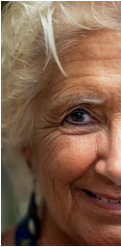Close up image of a senior woman smiling and looking at the camera